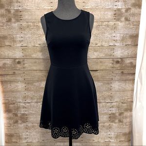 Black sleeveless sheath dress. Size medium. Delicate cut out hem.